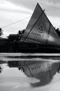 Canoe reflected in water puddle