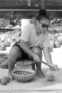 Woman splitting coconut