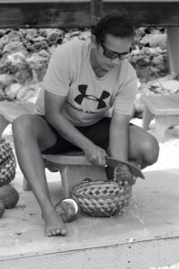 Woman splitting coconut