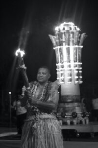 Torch bearer in front of Games' flame