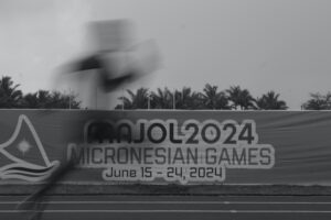 Blurred image of runner against the Games banner